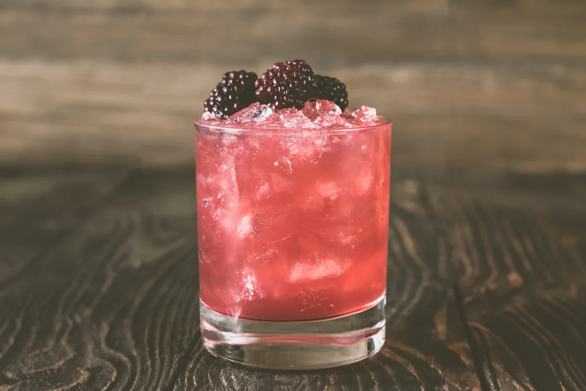 Bourbon Renewal cocktail garnished with blackberries