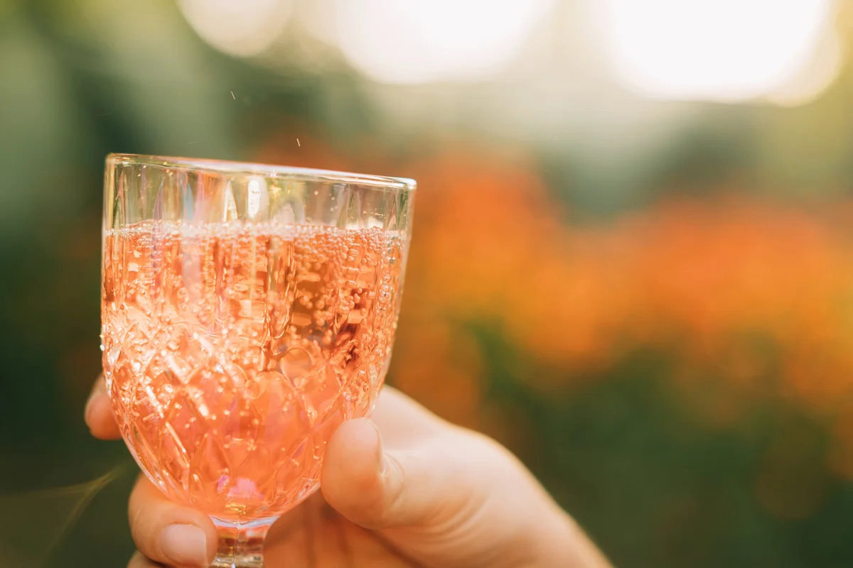 Female hand with glass of alcoholic drink