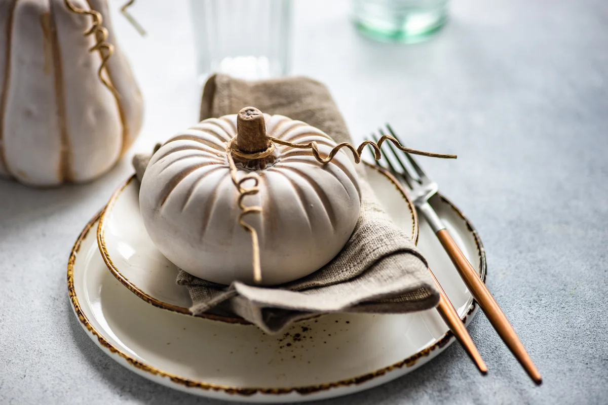 White pumpkin on place setting