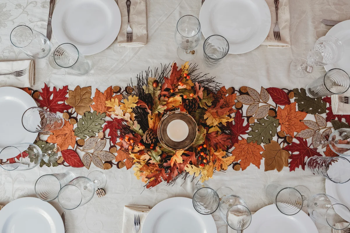 a table runner made of autumn leaves
