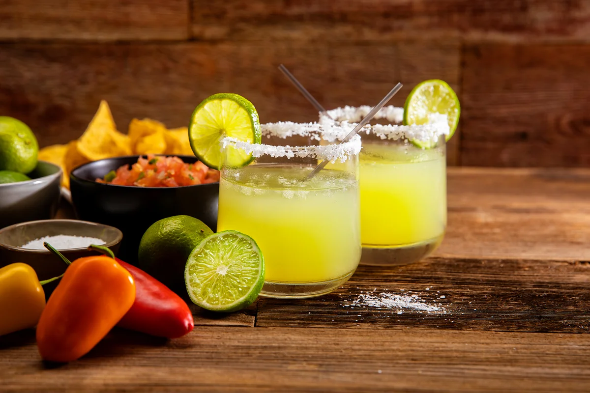 two modern margarita glasses with a rim of salt