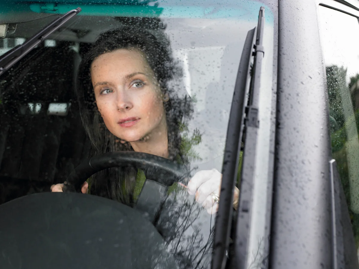 Woman driving in rain