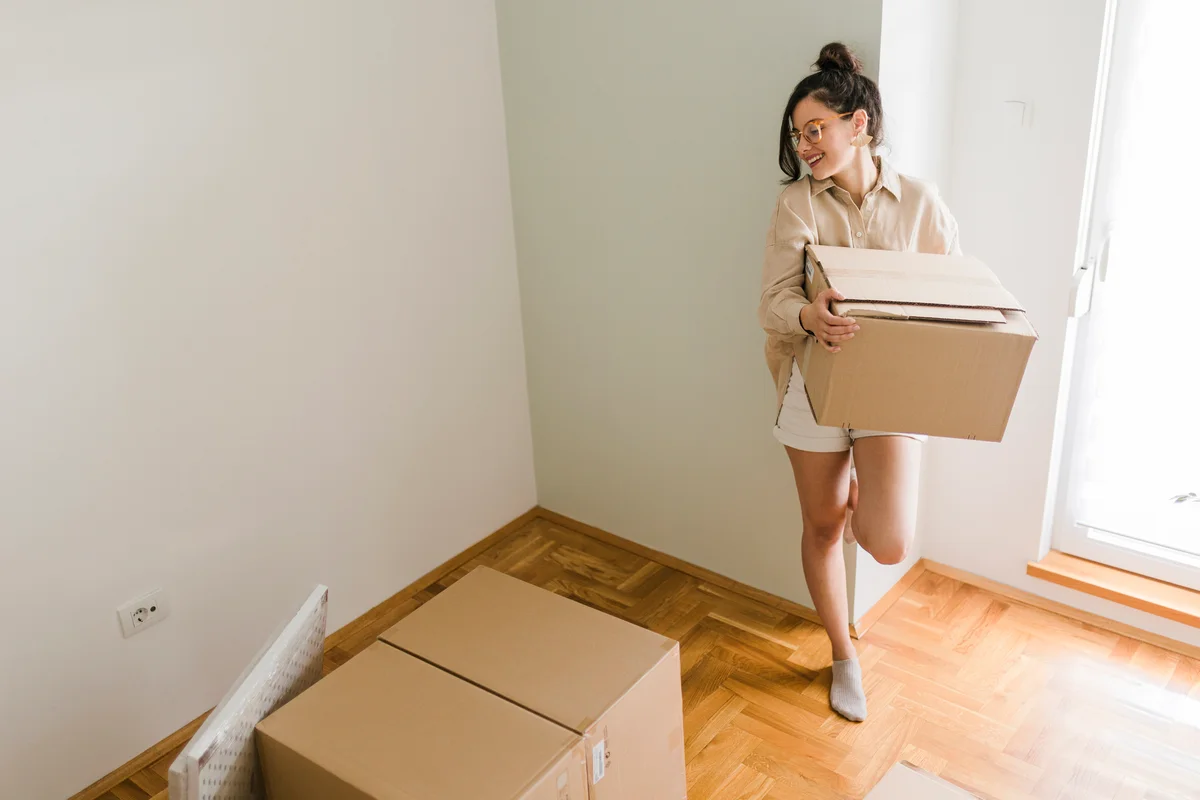 Woman carrying boxes upstairs