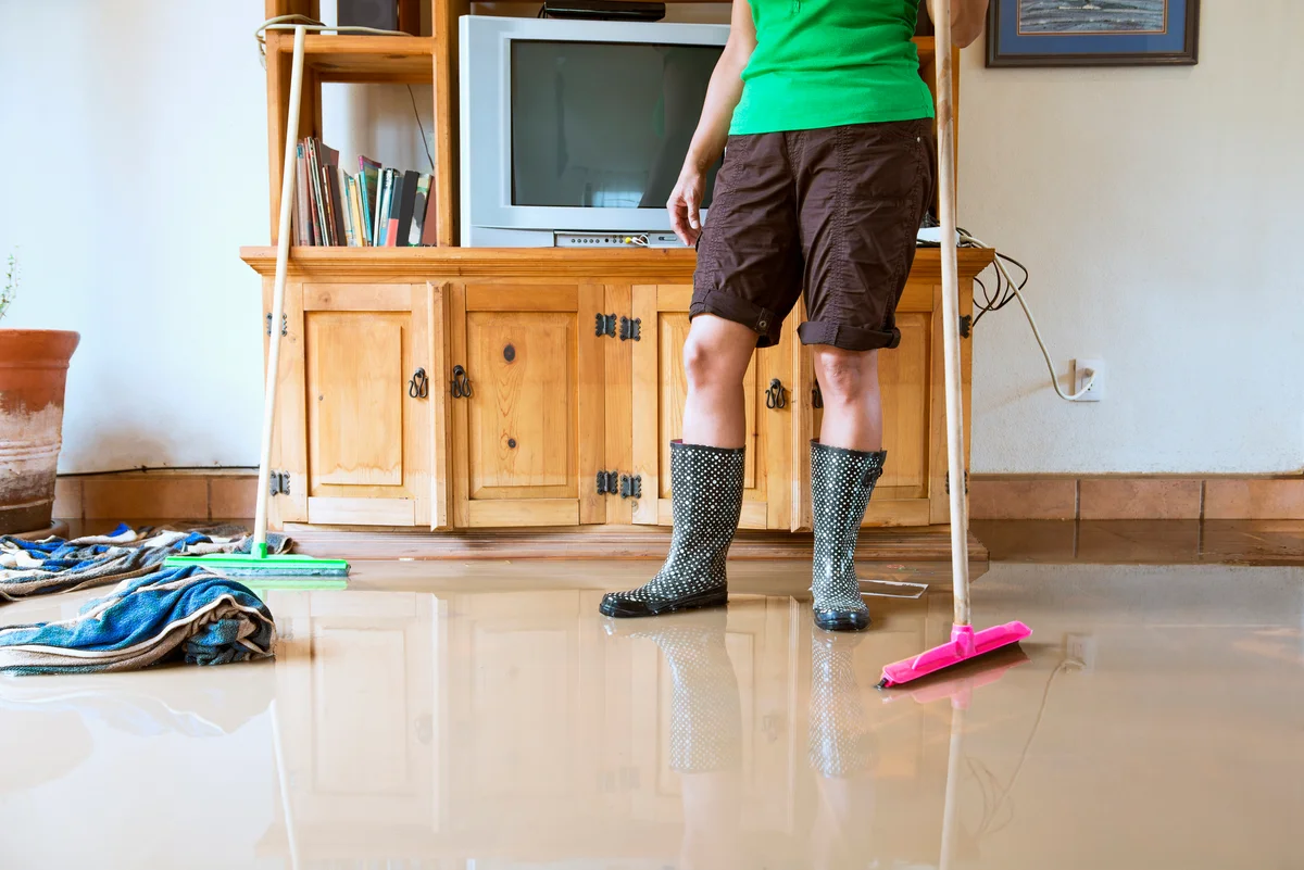 Woman cleaning up a flood
