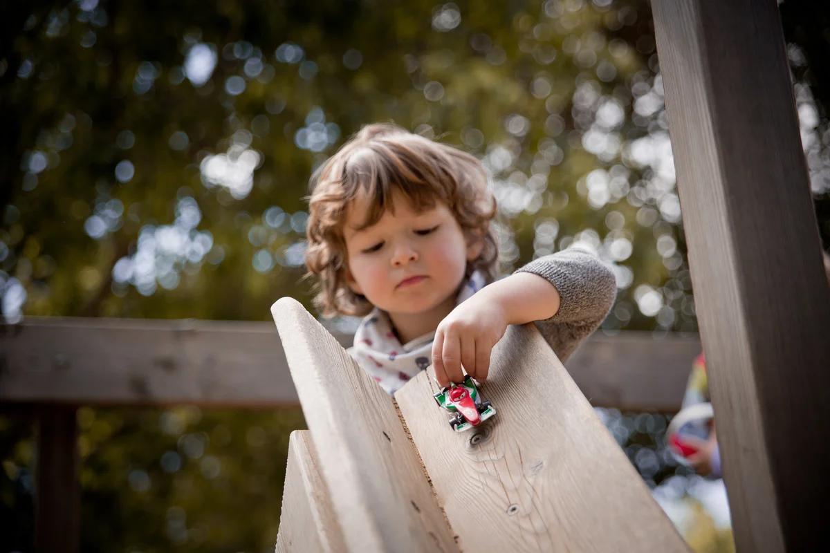 Toddler playing with cars
