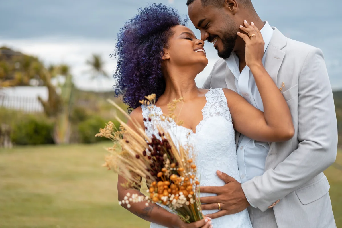 Happy couple posing, bride holding dried bouquet