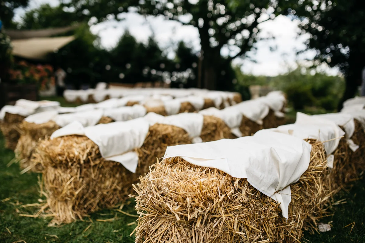Hay bales at wedding for guest seating
