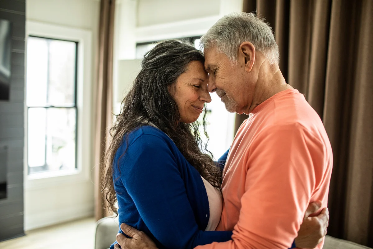 Senior couple dancing in living room