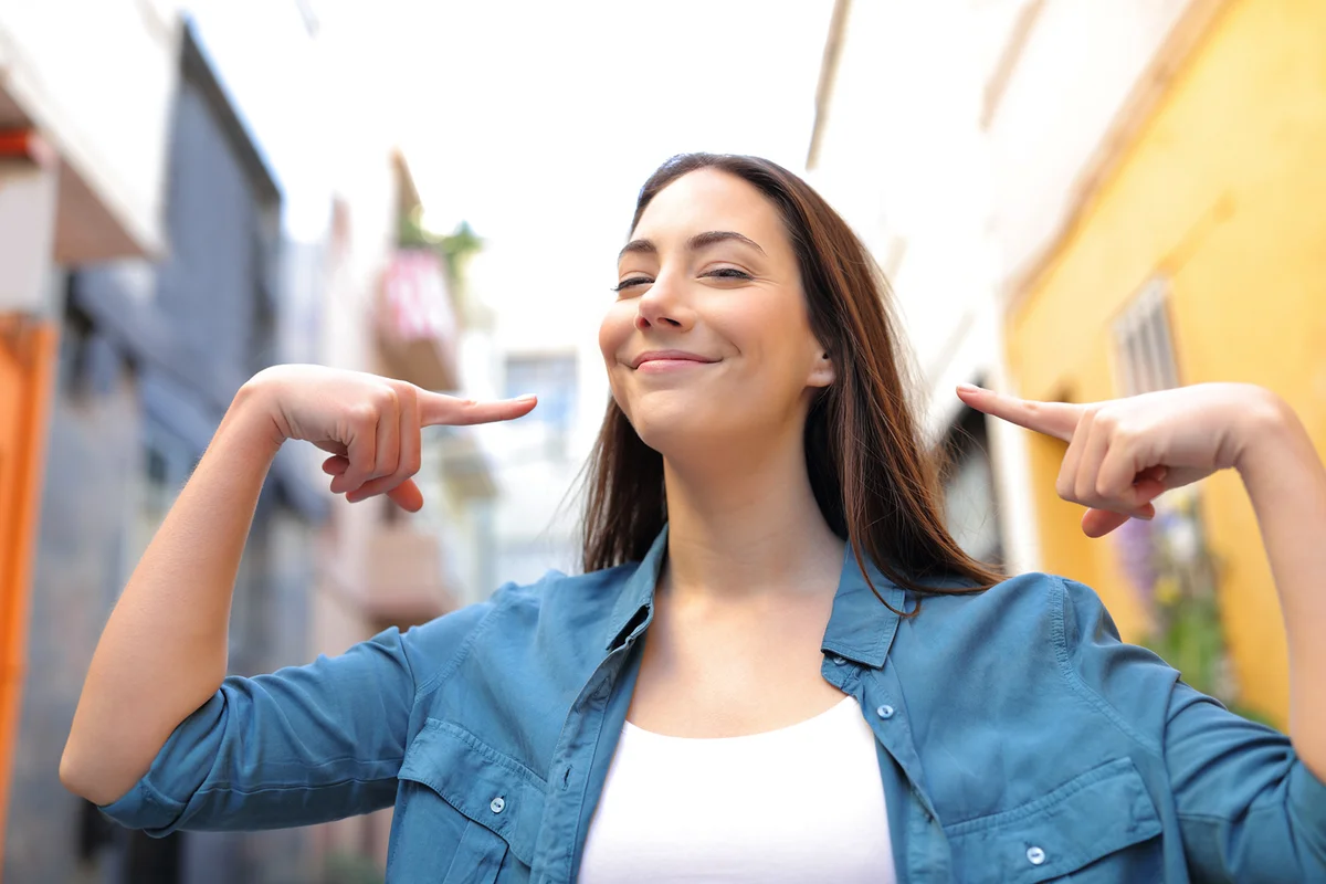 Proud woman pointing herself in the street