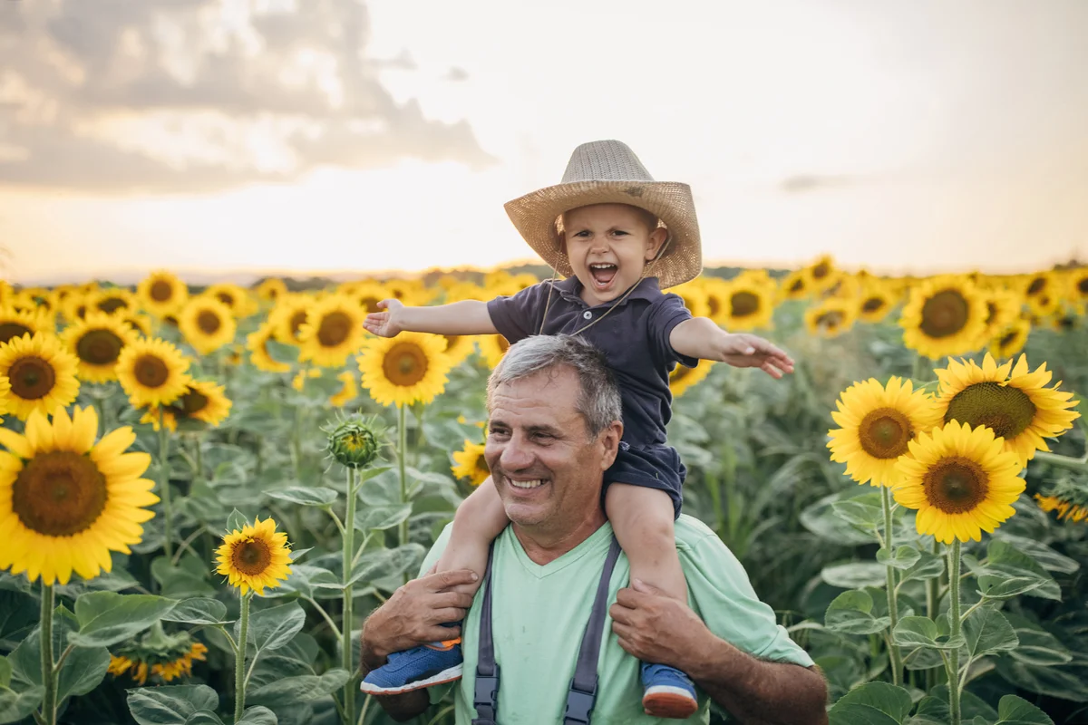 Happy farmers in a field of blooming sunflowers