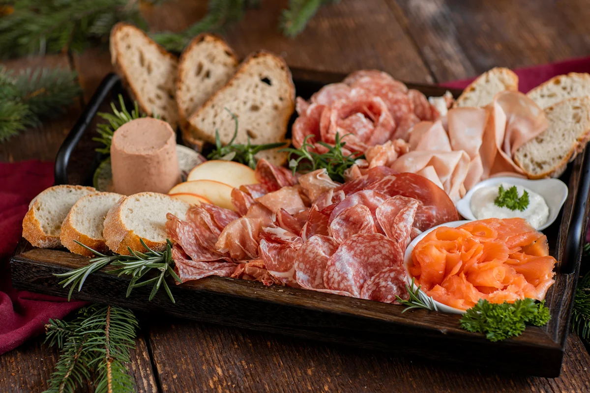 Appetizer Charcuterie Board with ham, salami, salmon and bread