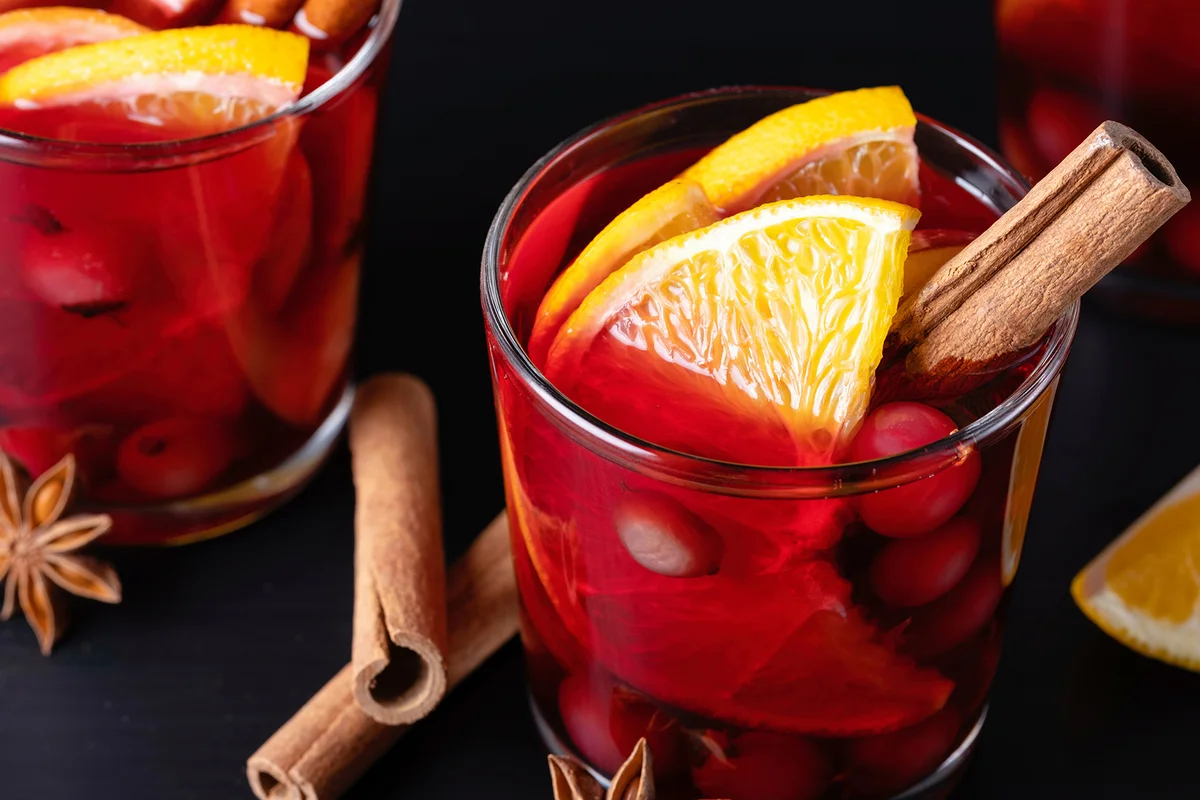 Mulled wine in glass glasses with spices and citrus fruits