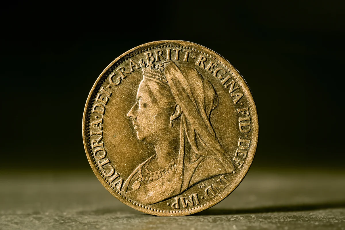 antique one-penny coin from the British imperial era, showing the profile of Queen Victoria