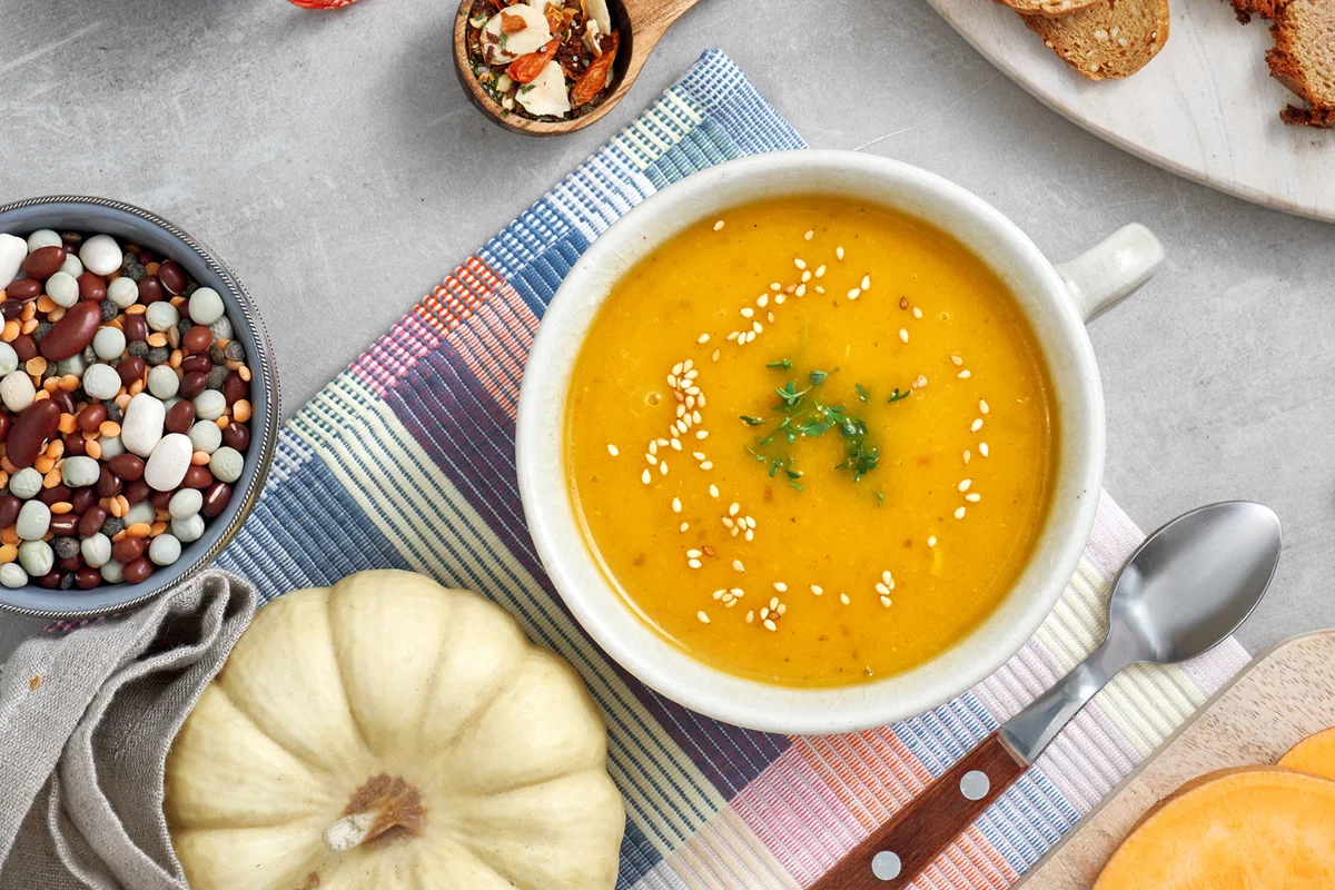 Pumpkin, mixed beans and sweet potato cream soup in ceramic bowl