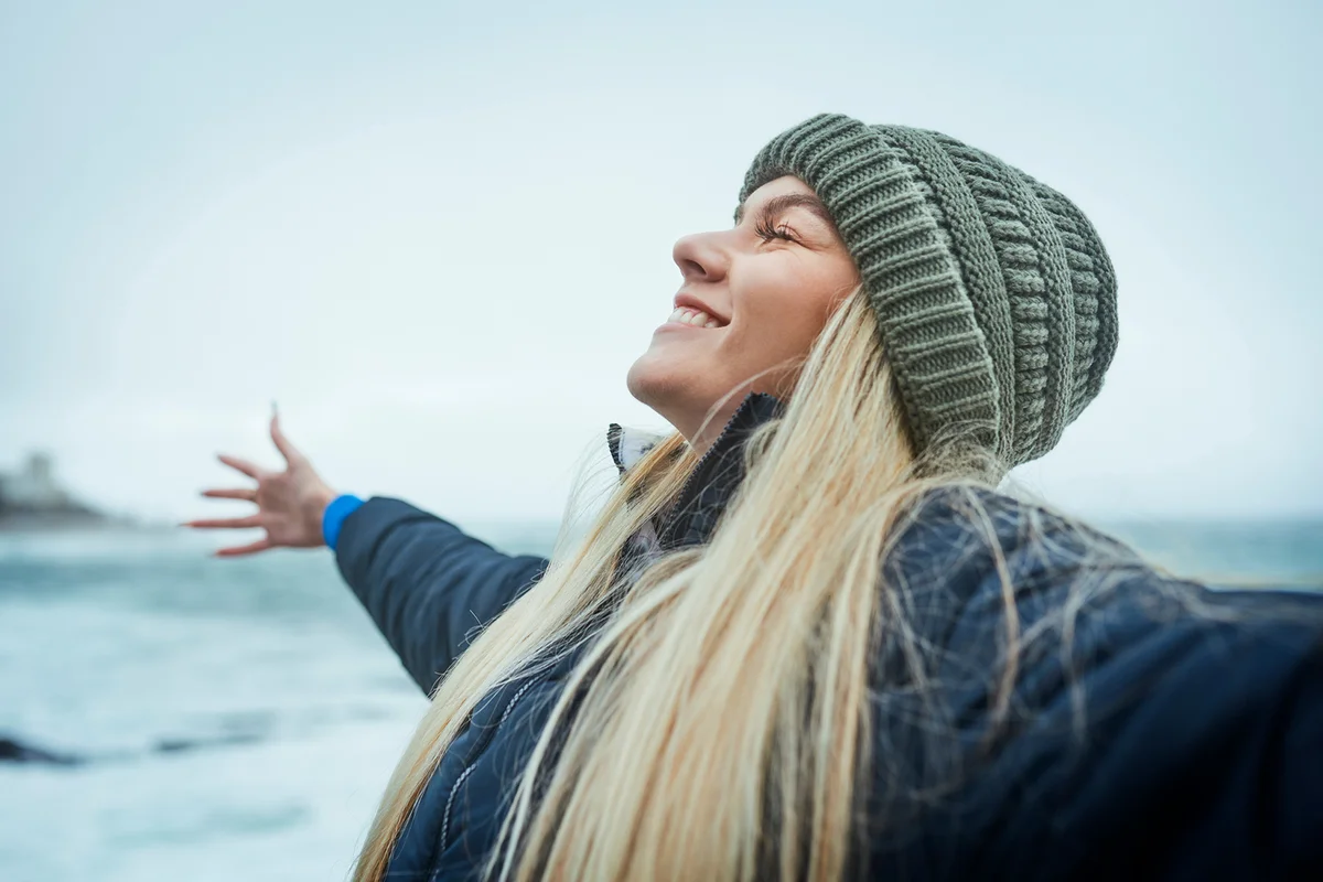 Woman, success and freedom by beach