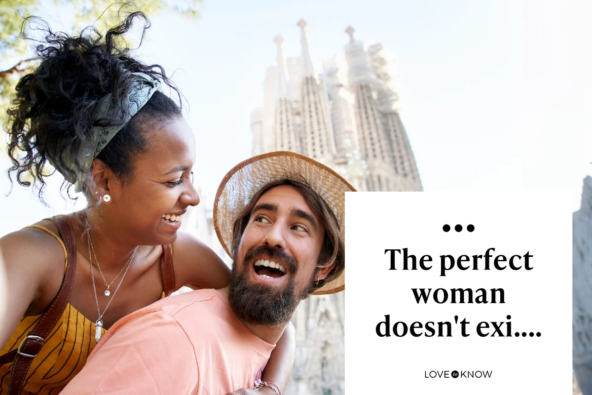 A happily just married couple taking a selfie with the Sagrada Familia behind