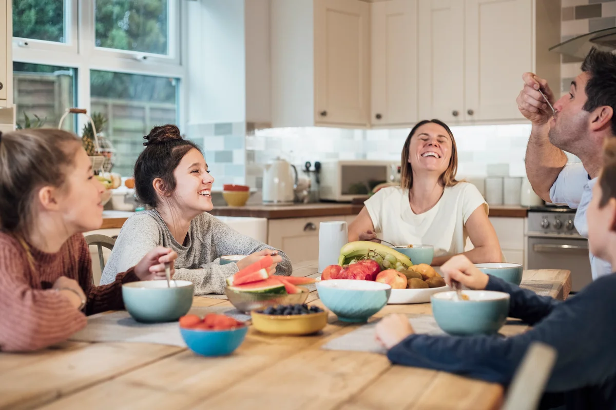 Family in their kitchen sitting at the dining table enjoying their meal