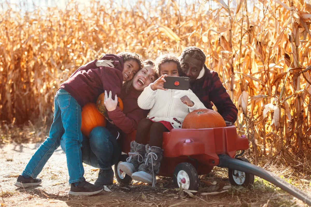 Family at the farm picking pumpkins