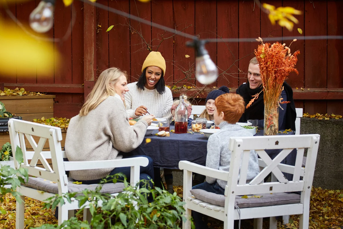 Smiling family and friends sitting at table for social gathering