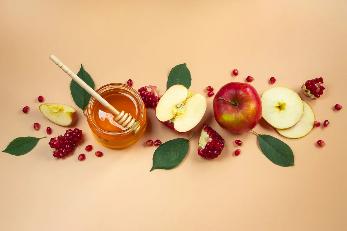 apples, pomegranate seeds, and honey