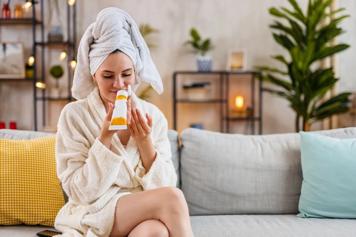 Woman fresh out the shower, smelling lotion