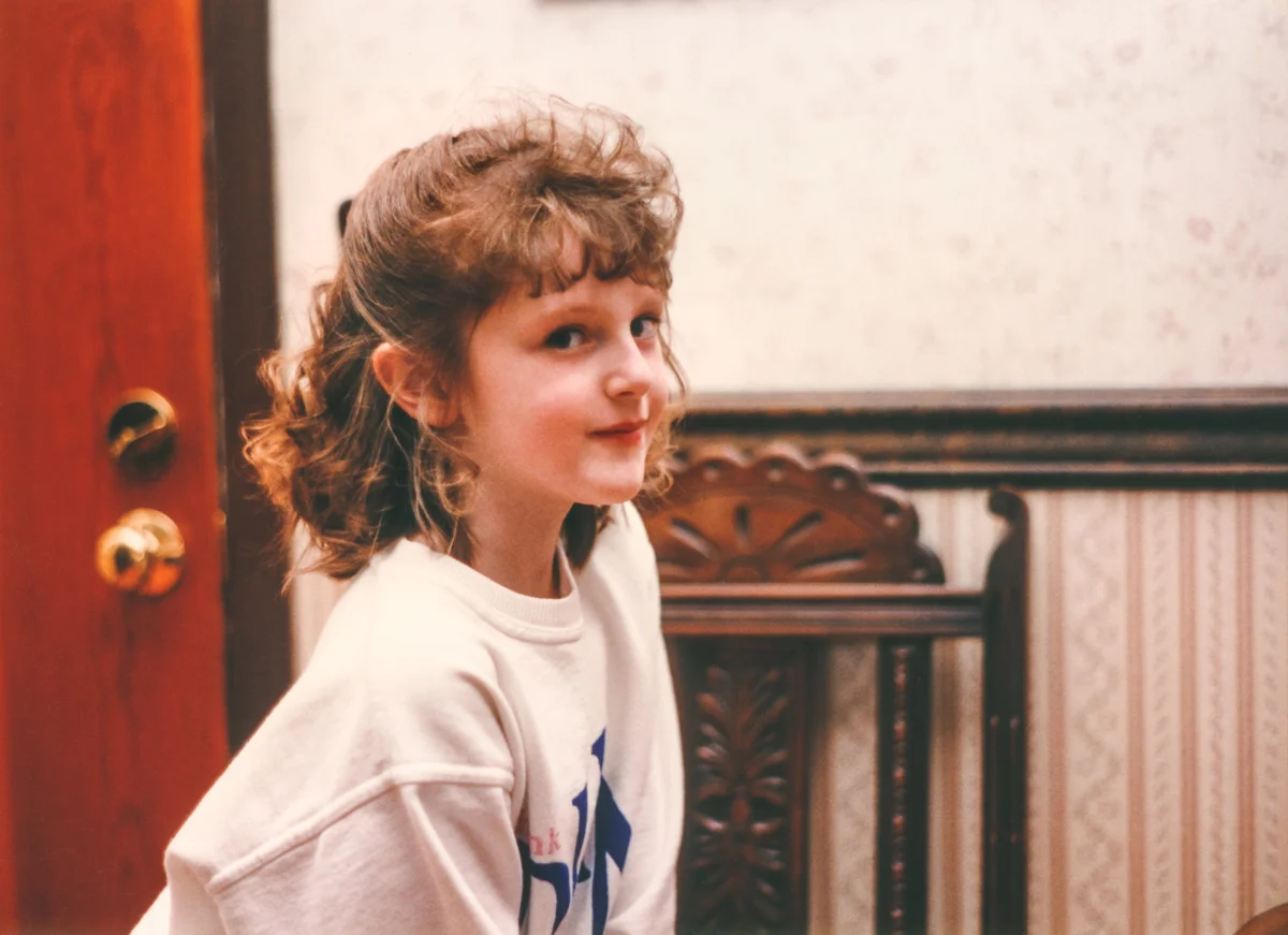 Girl in the 90s with feathery bangs