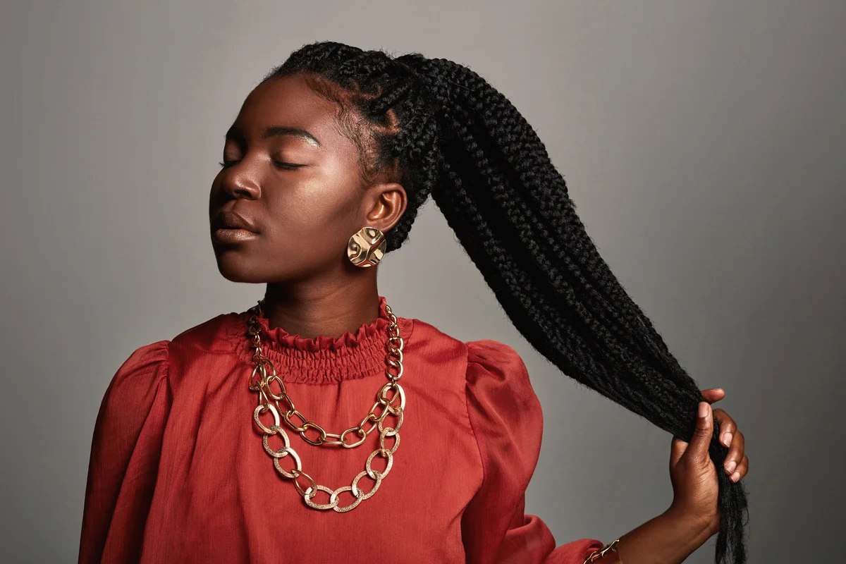 Woman with long box braids in pony tail