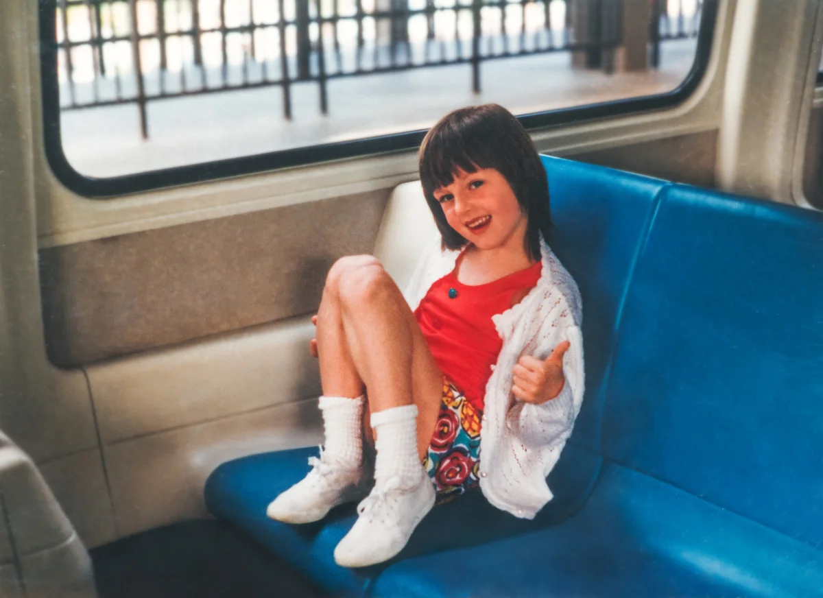Little girl on the bus with slight bowl cut