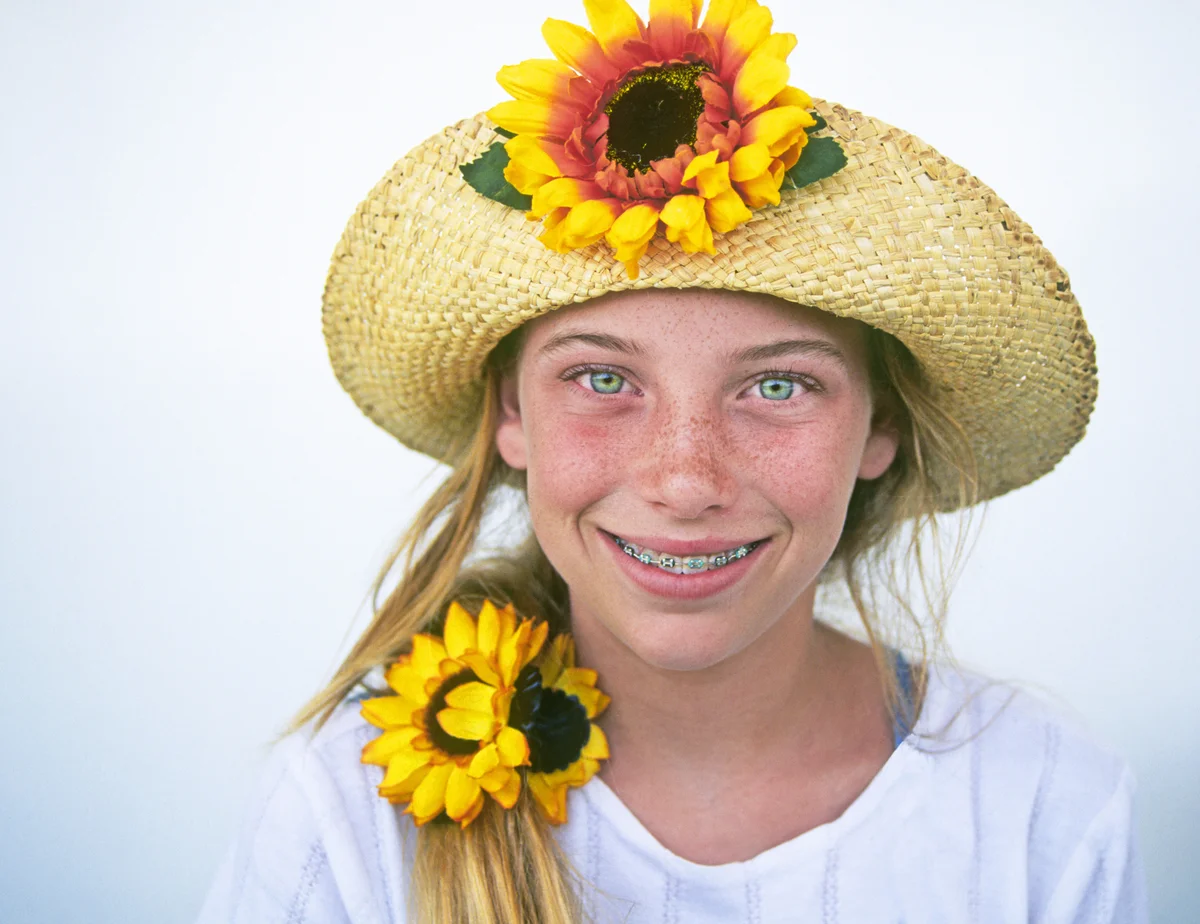 Girl wearing sunflower hat