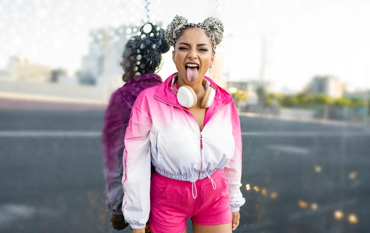 Cool girl sticking her tongue out with space buns