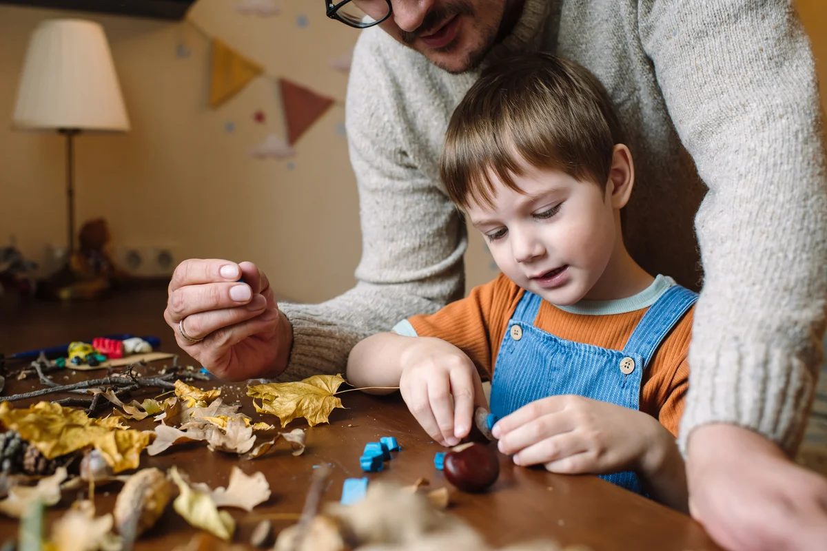 Dad and his son working on DIY autumn decor project