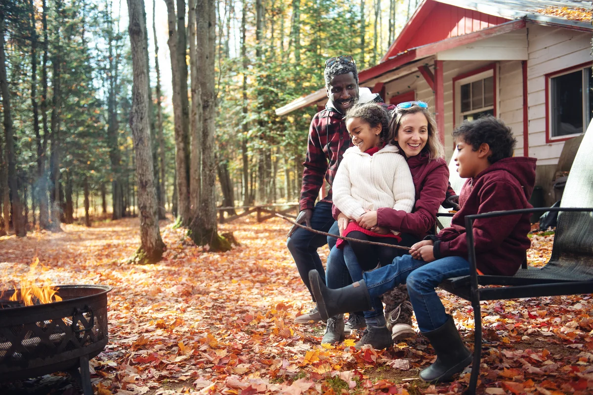 Adorable family having bonfire at camp