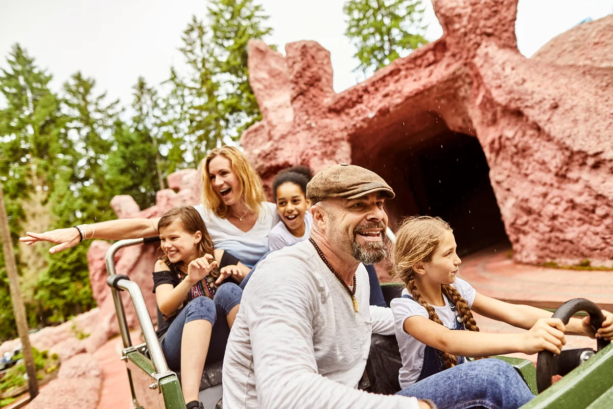 Happy family in an amusement park ride