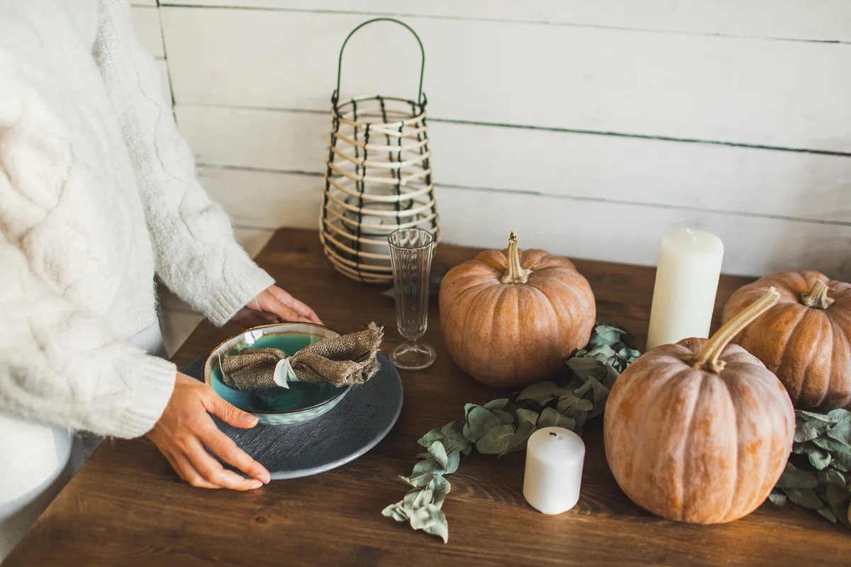 Fall themed holiday table setting arrangement for a seasonal party