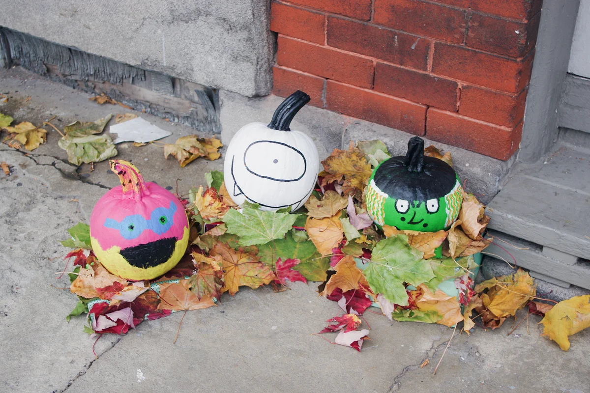 Pumpkins painted for Halloweensit on the doorstep of a house