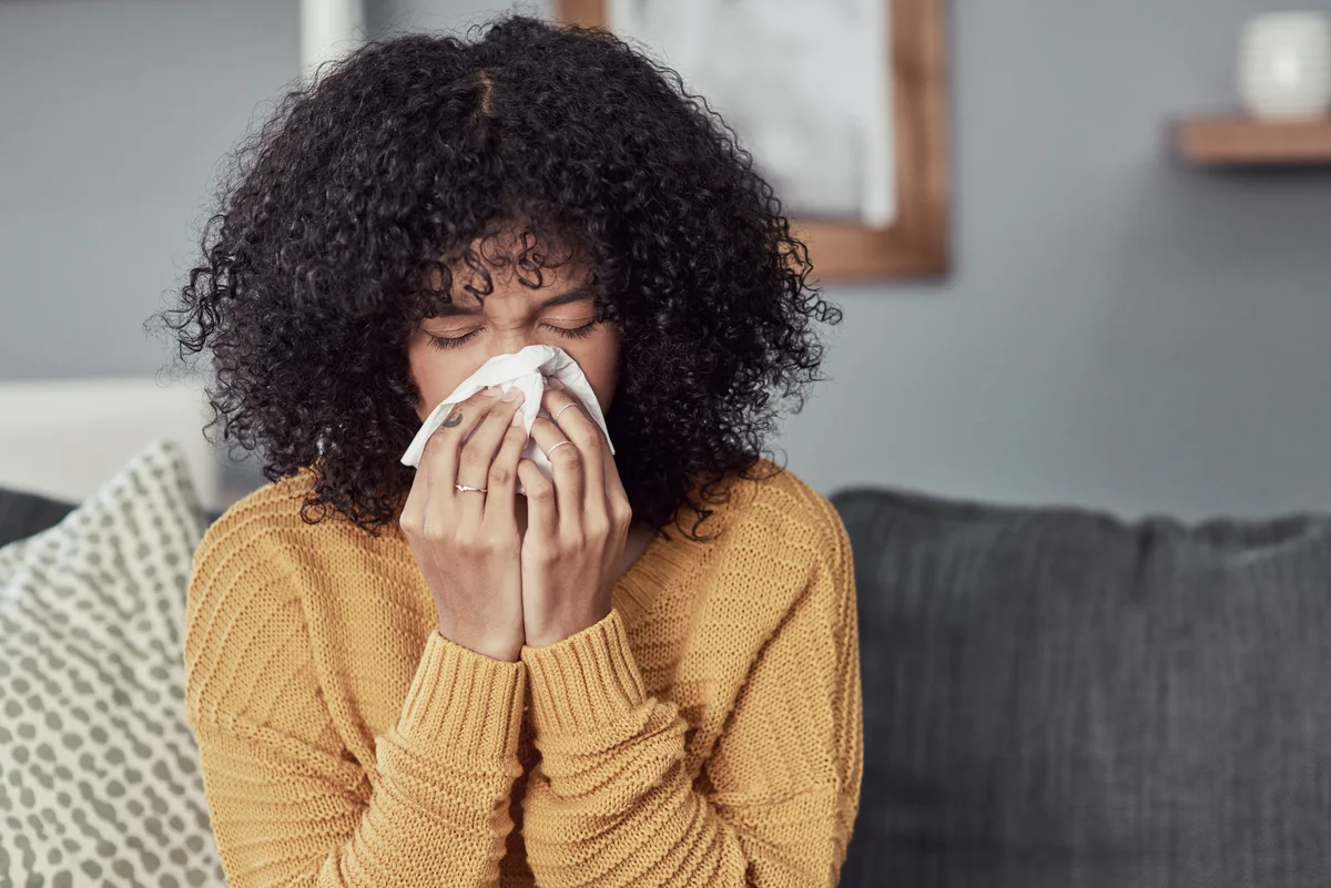woman blowing her nose