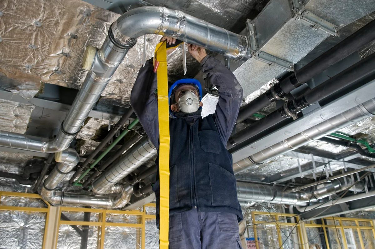 man working on air ducts