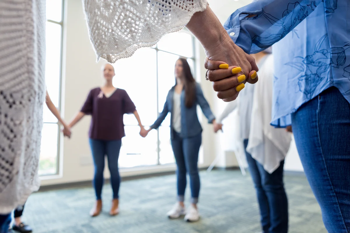 group of women holding hands