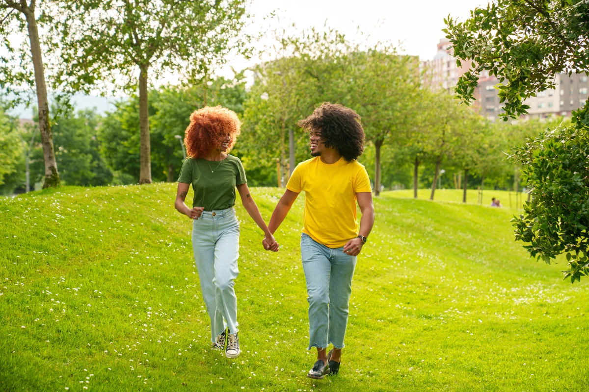 couple holding hands in the park