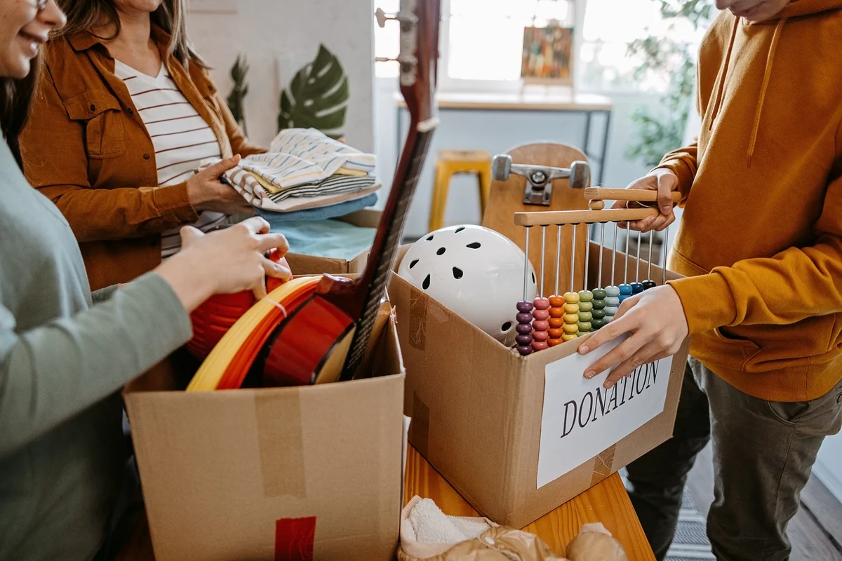People gathering items in boxes to donate