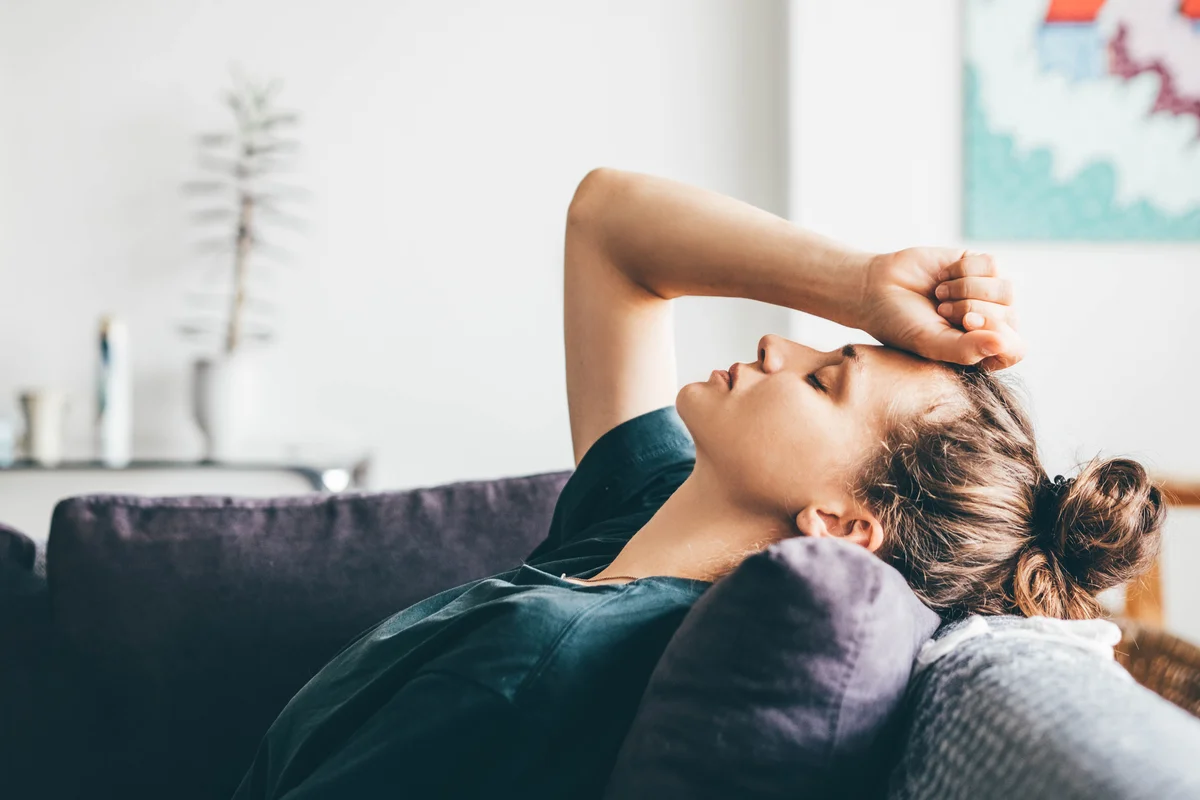 Girl laying on couch looking depressed and stressed