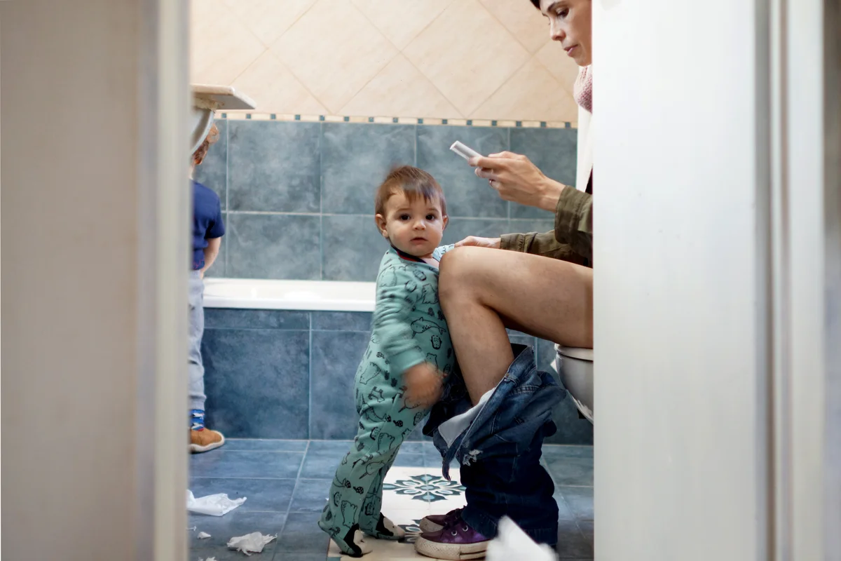 Mother with her children in the bathroom