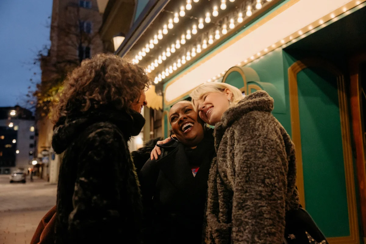 female-friends-greeting-outside-the-cinema
