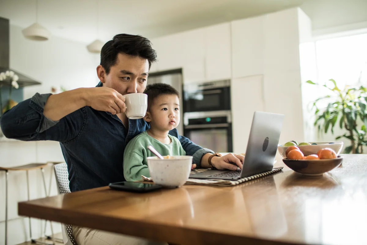 Dad working with child in his lap