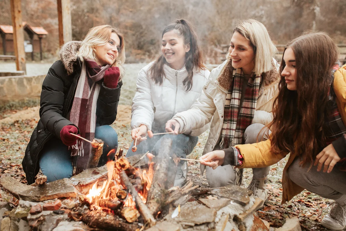 Female campers enjoying the bonfire