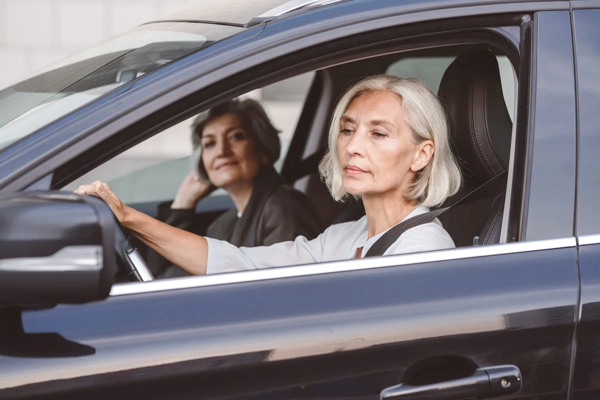 woman driving friend in car