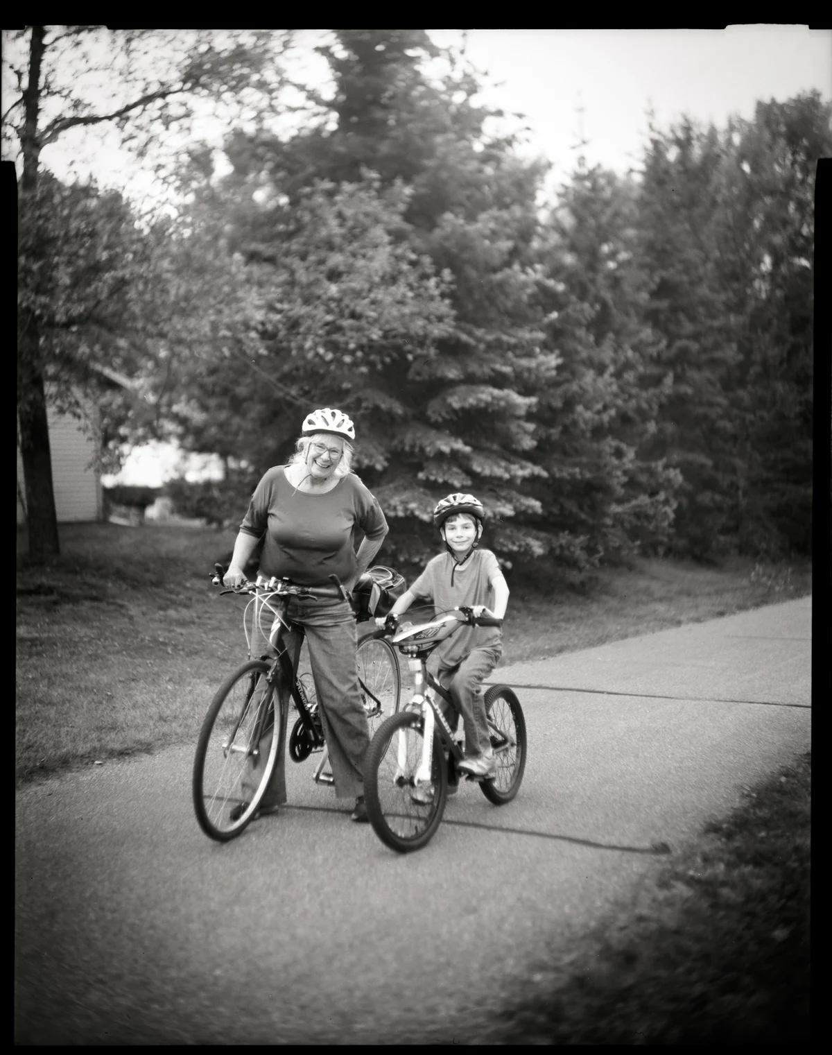 black and white film photography woman and child on bike