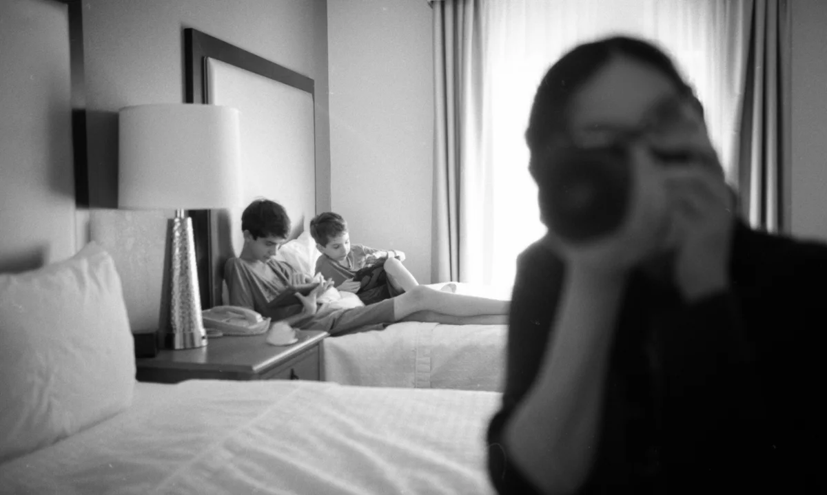 black and white film photography of family in hotel