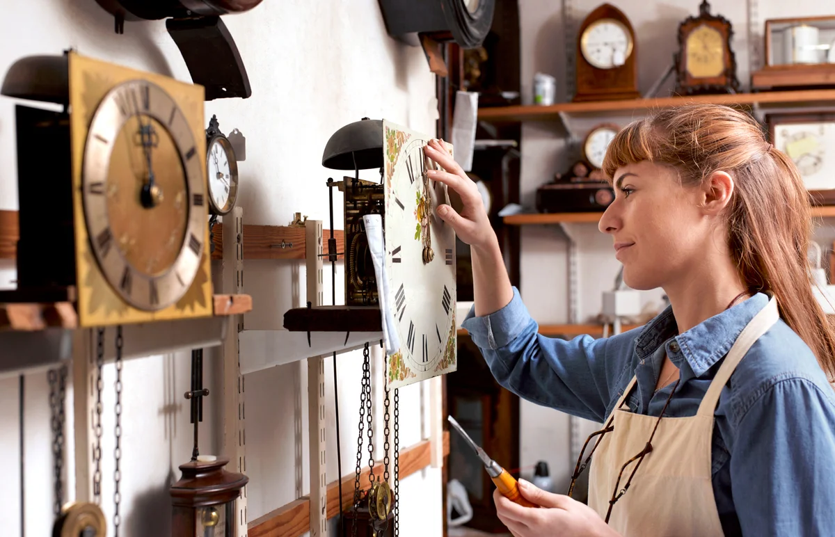 woman fixing antique clock