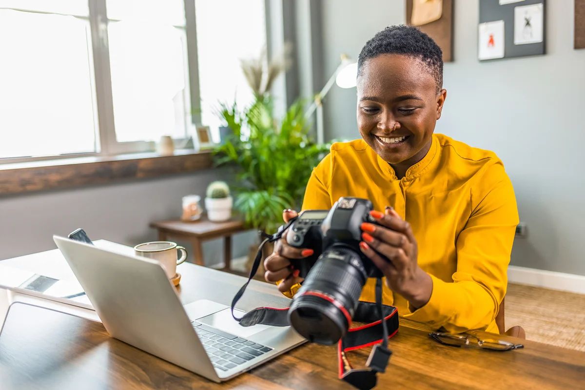 Happy young photographer holding a dslr camera